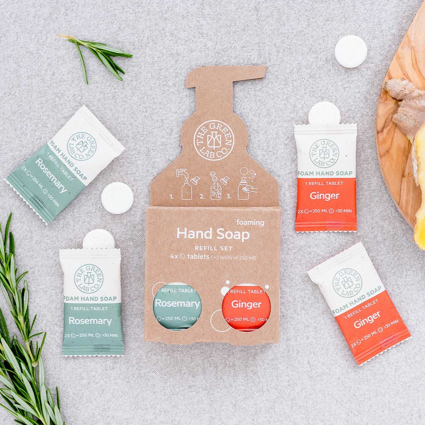 The Green Lab Co foaming hand soap refill set—Rosemary & Ginger tablets on a light fabric background.